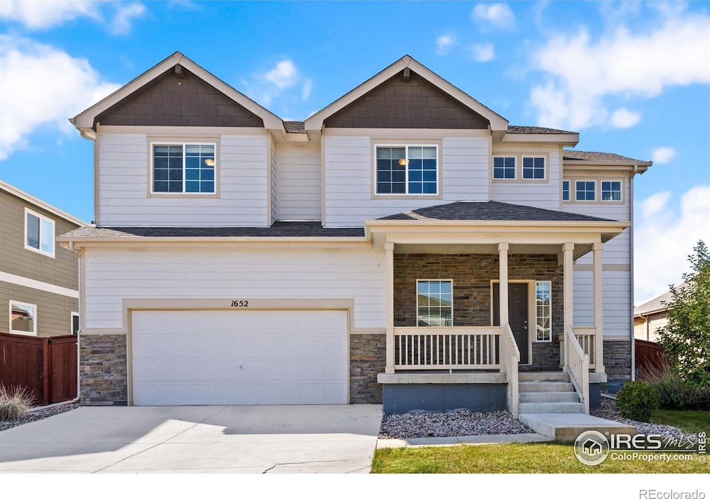 view of front of home featuring a garage and a porch