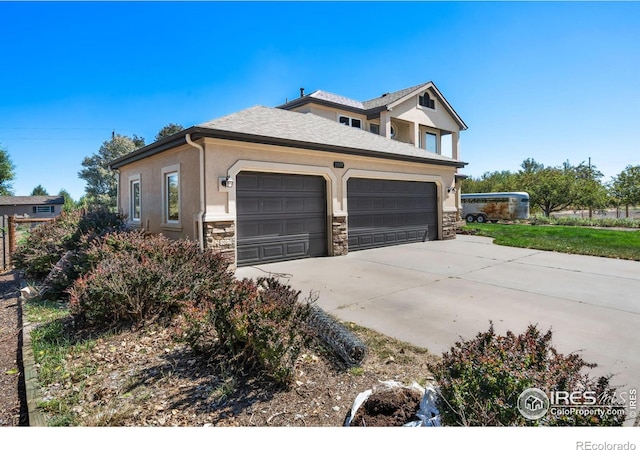 view of side of home featuring stucco siding, an attached garage, driveway, and stone siding