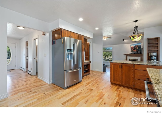 kitchen featuring brown cabinets, light wood-style floors, and high end refrigerator