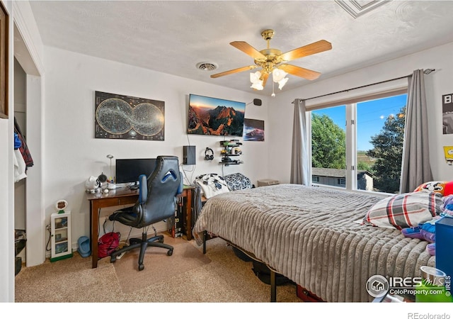 carpeted bedroom featuring a ceiling fan and visible vents