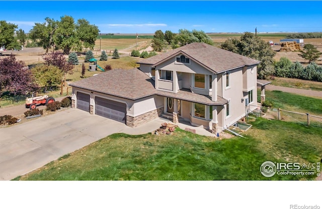 view of front facade featuring driveway, an attached garage, fence, a front yard, and stucco siding