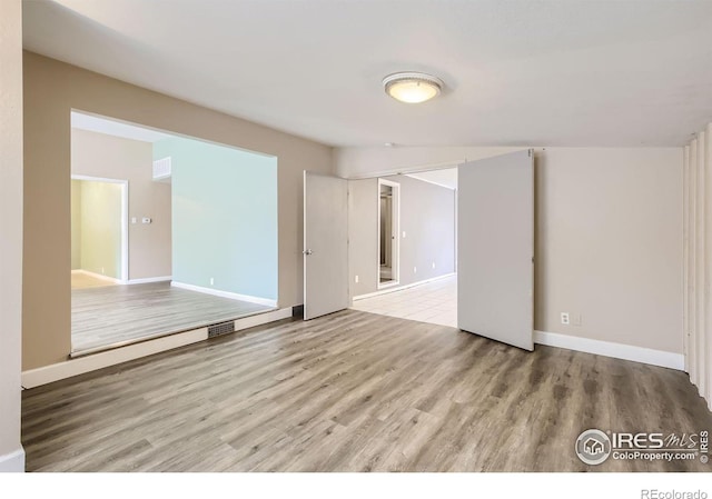 spare room featuring light wood-type flooring