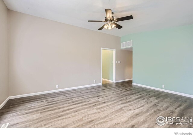 spare room featuring light hardwood / wood-style floors and ceiling fan