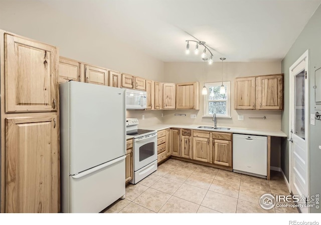 kitchen with light tile patterned flooring, light brown cabinetry, sink, pendant lighting, and white appliances