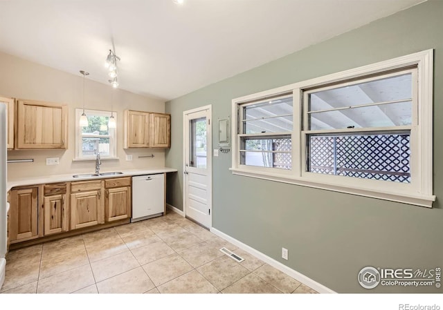 kitchen with sink, light tile patterned floors, hanging light fixtures, white dishwasher, and vaulted ceiling