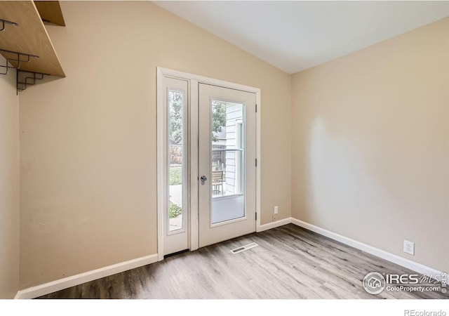 entryway with lofted ceiling and light hardwood / wood-style floors