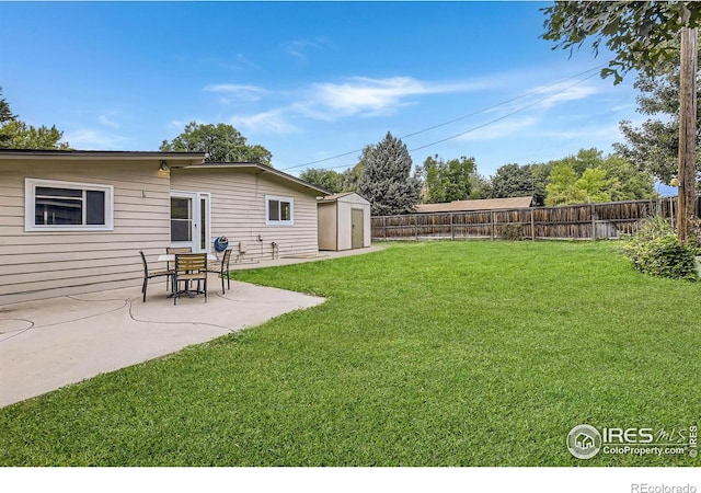 view of yard with a storage unit and a patio area