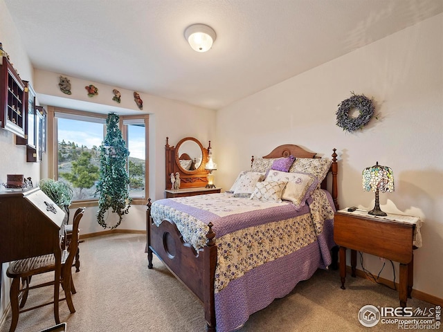 bedroom featuring light colored carpet