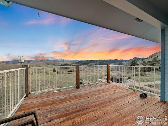 deck at dusk with a mountain view