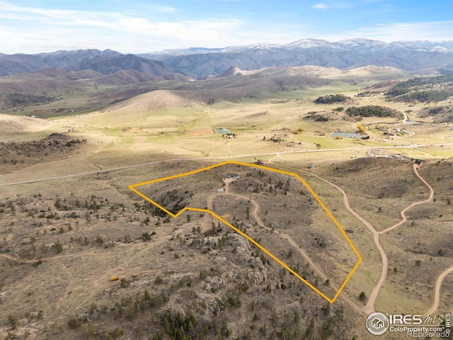 birds eye view of property with a mountain view