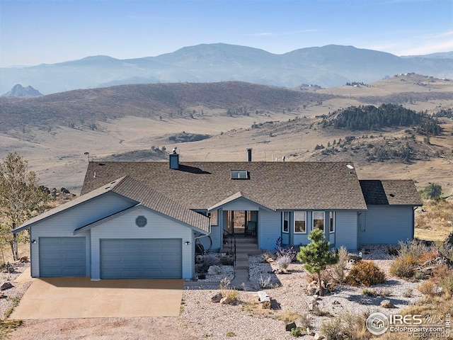 ranch-style house featuring a mountain view and a garage