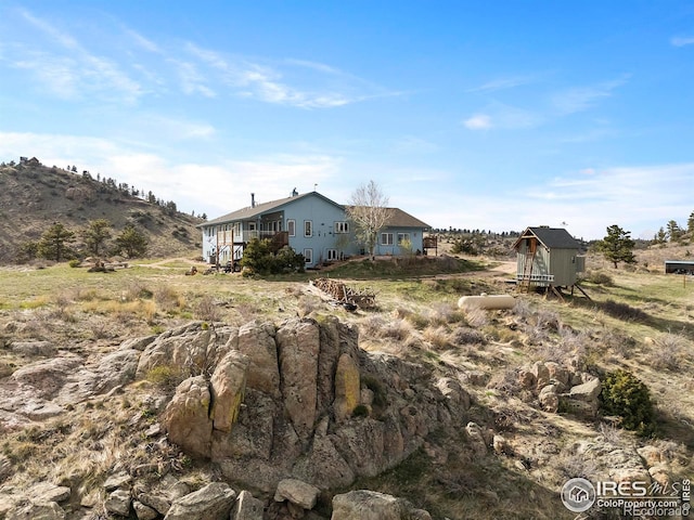 exterior space with a mountain view and a storage shed