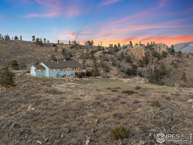 yard at dusk featuring a mountain view