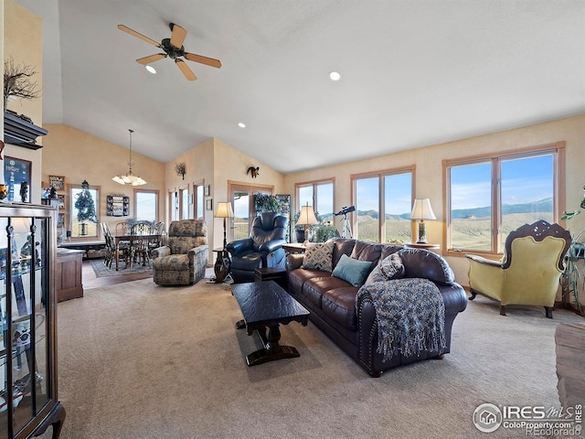 carpeted living room with a mountain view, ceiling fan, and lofted ceiling