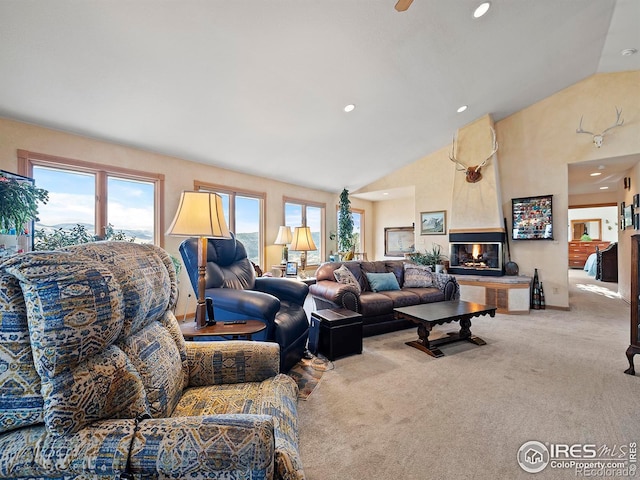 carpeted living room with a multi sided fireplace and vaulted ceiling