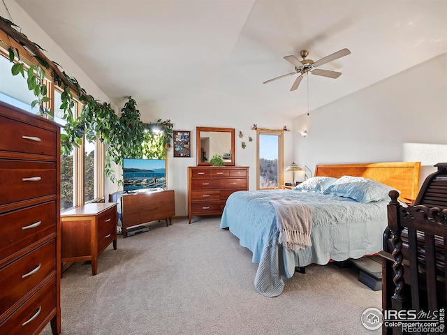 carpeted bedroom featuring ceiling fan and vaulted ceiling