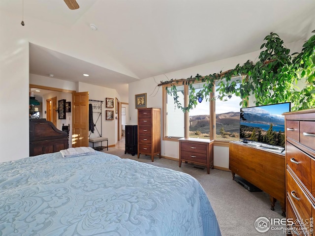 carpeted bedroom with ceiling fan and vaulted ceiling