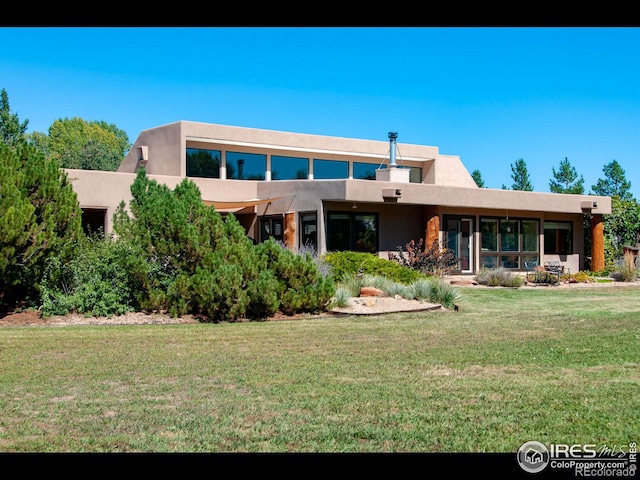 rear view of property featuring a yard