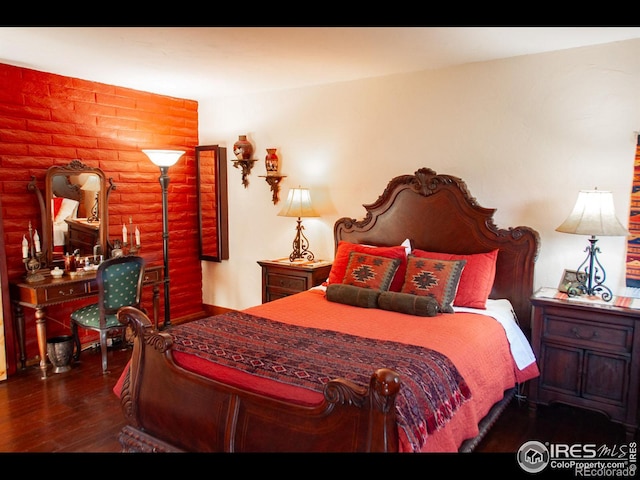 bedroom featuring dark hardwood / wood-style flooring