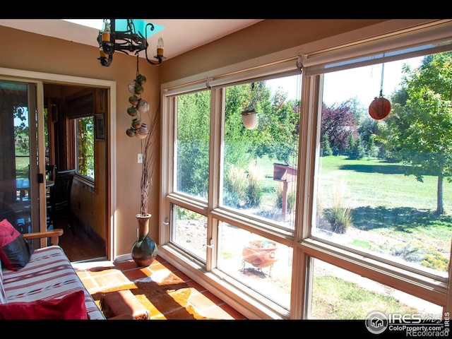 sunroom with a notable chandelier