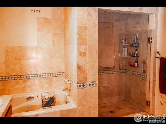 bathroom with vanity and separate shower and tub