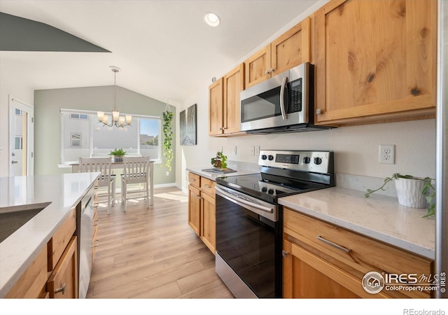 kitchen featuring vaulted ceiling, pendant lighting, stainless steel appliances, light wood-type flooring, and a notable chandelier