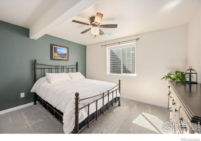 carpeted bedroom with ceiling fan and beam ceiling