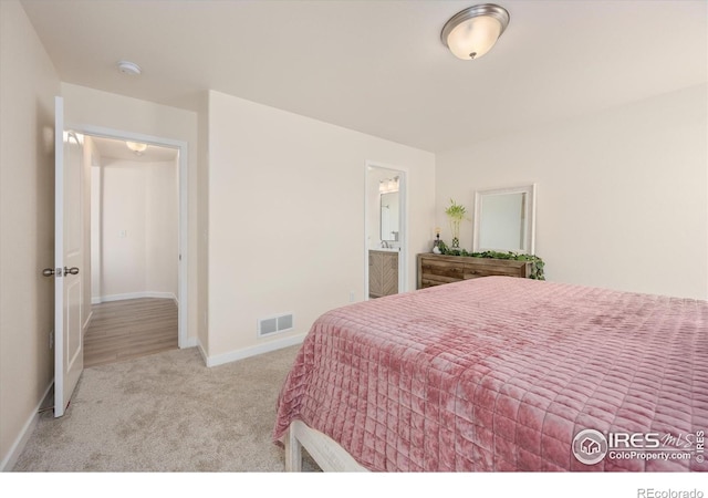 carpeted bedroom featuring connected bathroom