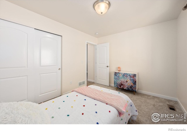 carpeted bedroom with a closet