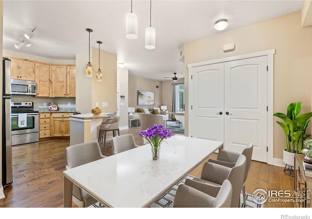 dining room featuring ceiling fan and dark hardwood / wood-style floors