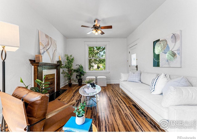 living room featuring ceiling fan and hardwood / wood-style floors