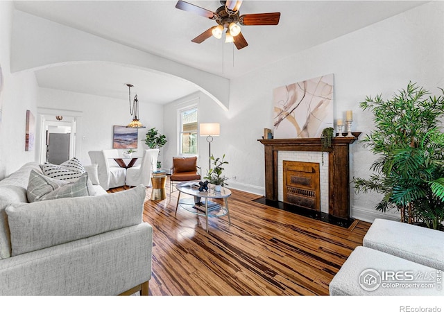 living room featuring hardwood / wood-style floors and ceiling fan