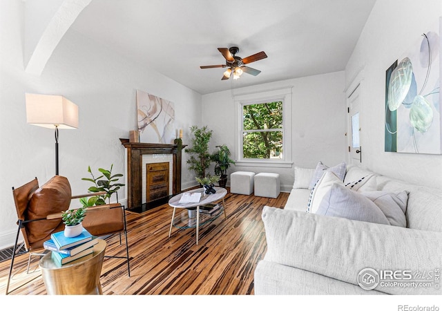 living room featuring ceiling fan and hardwood / wood-style flooring