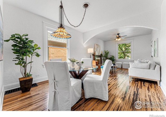 dining space with hardwood / wood-style flooring and ceiling fan