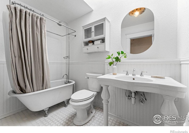 full bathroom with shower / bath combination with curtain, sink, tile patterned flooring, and toilet