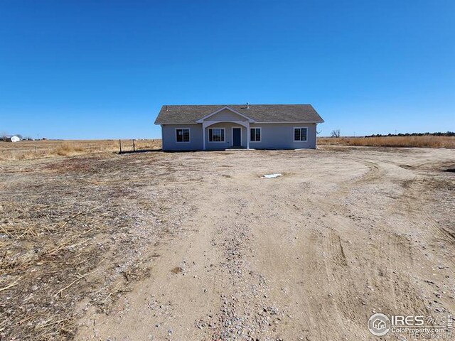 view of front of home with a rural view