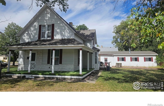 farmhouse-style home with a porch and a front lawn