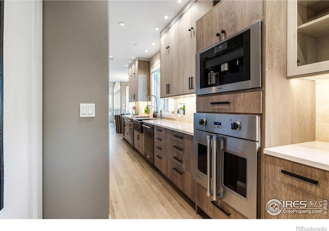 8001 Fairview Rd, Boulder, CO 80303 - kitchen with stainless steel appliances, light wood-style floors, light countertops, tasteful backsplash, and recessed lighting