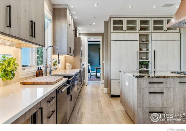 8001 Fairview Rd, Boulder, CO 80303 - kitchen featuring light wood finished floors, light stone countertops, modern cabinets, wall chimney exhaust hood, and glass insert cabinets