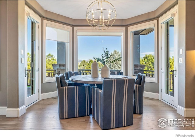 8001 Fairview Rd, Boulder, CO 80303 - dining area with a chandelier, wood finished floors, baseboards, and plenty of natural light