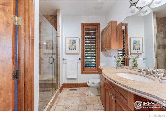8001 Fairview Rd, Boulder, CO 80303 - full bath with vanity, toilet, baseboards, a shower stall, and stone finish floors