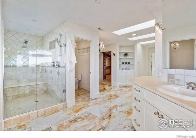 8001 Fairview Rd, Boulder, CO 80303 - full bathroom with a stall shower, a chandelier, a skylight, vanity, and toilet