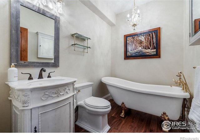 8001 Fairview Rd, Boulder, CO 80303 - bathroom with a freestanding bath, wood finished floors, vanity, toilet, and a chandelier