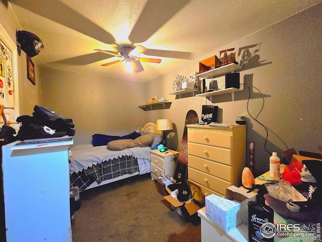 carpeted bedroom featuring ceiling fan and a textured ceiling