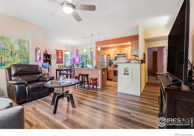 living room with light wood-type flooring and ceiling fan