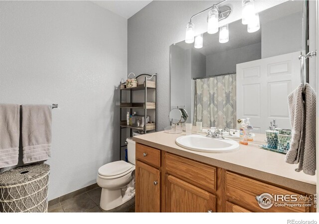 bathroom with vanity, toilet, and tile patterned floors