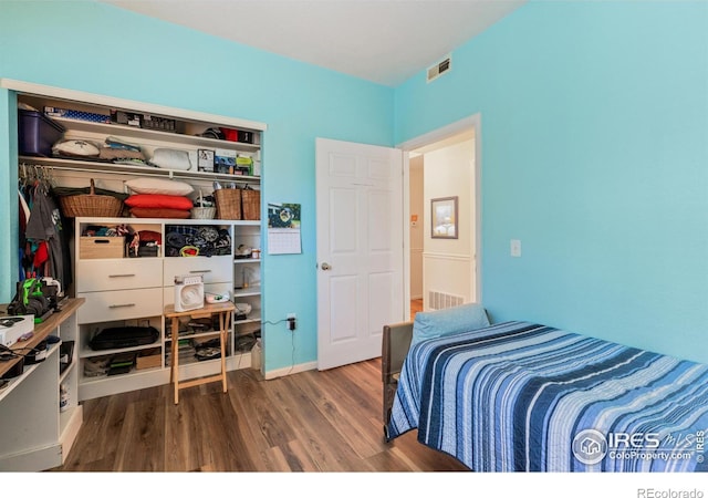 bedroom with hardwood / wood-style flooring