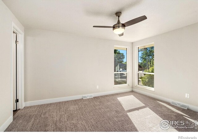 spare room with ceiling fan and carpet floors