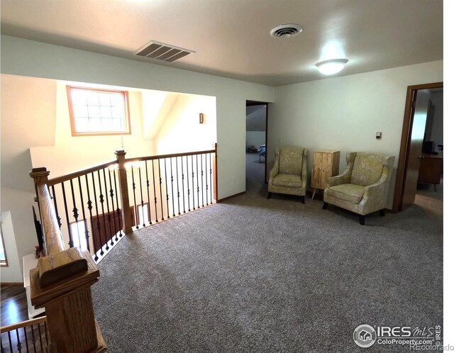 sitting room with carpet floors and visible vents