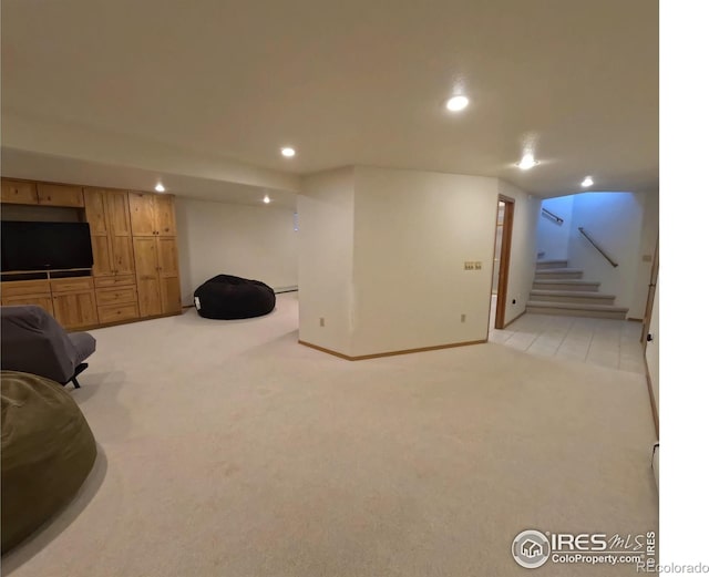 living area with recessed lighting, light colored carpet, and stairway